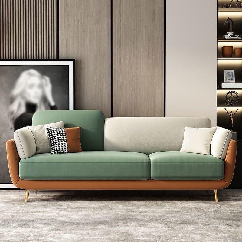 Green and brown sofa oak inside in a modern living room setting with decor elements.
