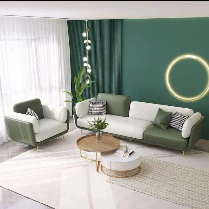 Modern living room with green and white furniture, including a sofa and armchair.