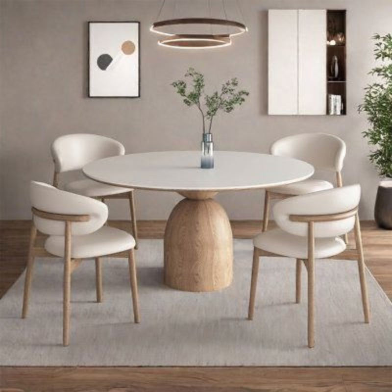 Oak Inside Dining room with a round wooden table and white chairs on a gray rug.